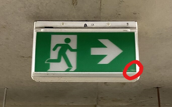 Red circle showing where to find size of replacement exit sign